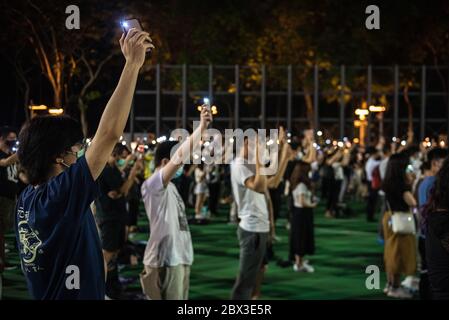Participants shine their phone lights during the anniversary rally.Thousands of Hong Kong residents attended a rally commemorating the 31st anniversary of the Tiananmen Square Massacre. Rally attendees chanted slogans, lit candles and held a moment of silence in remembrance of the day. Stock Photo
