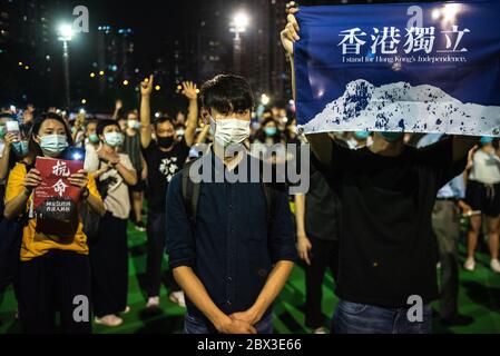 A man holds a banner advocating for Hong Kong independence during the anniversary rally.Thousands of Hong Kong residents attended a rally commemorating the 31st anniversary of the Tiananmen Square Massacre. Rally attendees chanted slogans, lit candles and held a moment of silence in remembrance of the day. Stock Photo