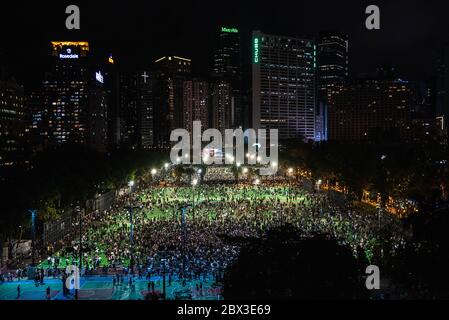 Crowd of participants during the anniversary rally.Thousands of Hong Kong residents attended a rally commemorating the 31st anniversary of the Tiananmen Square Massacre. Rally attendees chanted slogans, lit candles and held a moment of silence in remembrance of the day. Stock Photo