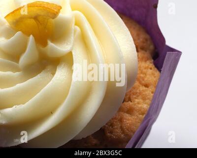 Close Up Of An Iced Cupcake Decorated With A Wedge Of Lemon, London, UK. Stock Photo