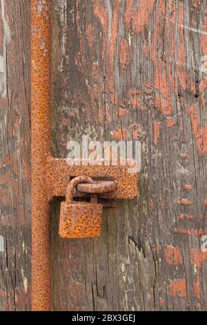 Rusty, iron padlock on an old wooden door Stock Photo