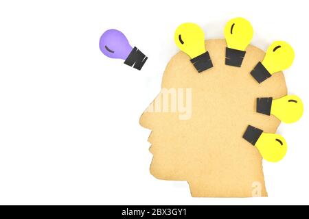 Think outside the box, be original, game changer and trend setter in business concept. Male profile head solhouette with different color light bulb. Stock Photo