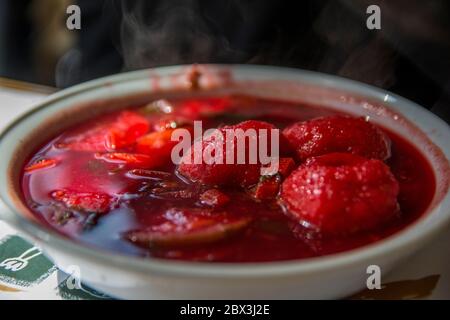 Traditional hot red beet Kubbe soup, a famous middle eastern dumplings soup dish, served in a bowl. Jerusalem, Israel. Stock Photo