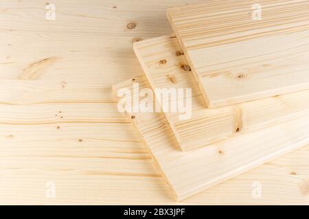 stack of spruce wood construction planks or boards on wooden background. Natural material carpentry diy industry furniture making concept. Stock Photo