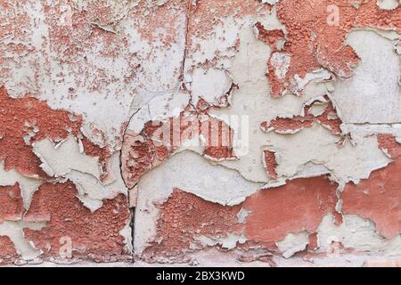 Old flaky cracked paint on gray wall, old paint background, selective focus Stock Photo