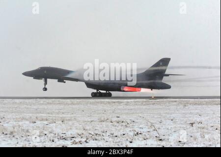 A U.S. Air Force B-1B Lancer stealth bomber aircraft from the 28th Bomb Wing, takes off on a wintry day in support Operation Odyssey Dawn at Ellsworth Air Force Base March 27, 2011 near Rapid City, South Dakota. Stock Photo