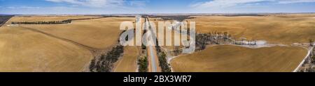 Aerial panoramic image of the South Coast Highway cutting through the drought afflicted wheat belt in Western Australia Stock Photo