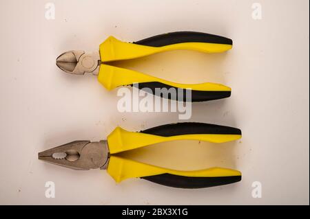 Different pliers on a white background. Close up. Manual locksmith and installation tools for home work Stock Photo