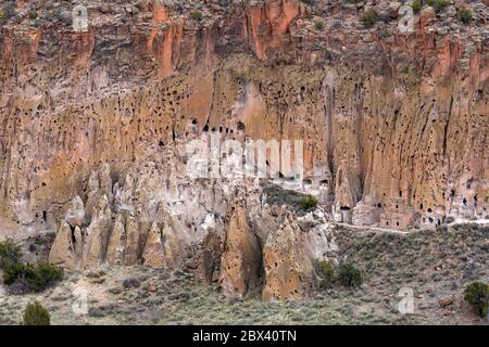NM00511-00....NEW MEXICO - Trail along the base of the the cliff , passing numerous cliff houses in Bandelier National Monument.