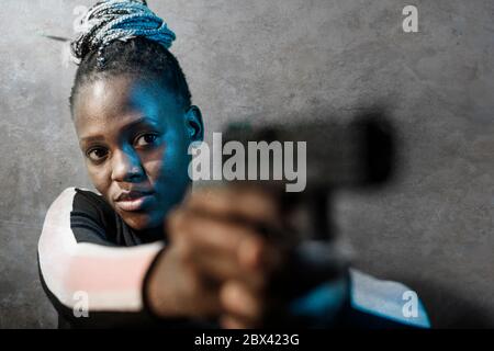 confused african american female secret agent with rifle, isolated on white  Stock Photo - Alamy