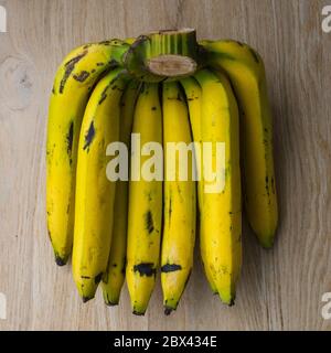 Bunch of bananas on wooden tiles background. Stock Photo