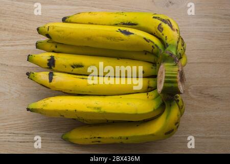 Bunch of bananas on wooden tiles background. Stock Photo