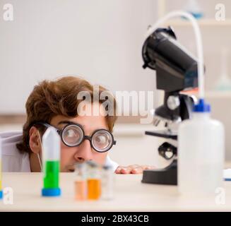 The funny crazy chemist doing experiments and tests Stock Photo