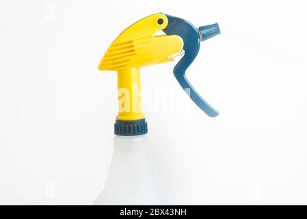 A close-up of the top portion of a professional liquid spray plastic dispenser bottle set on a plain white background. Stock Photo