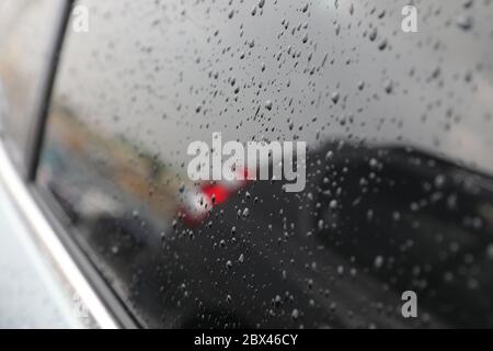 rain drops on car glass rainy day Stock Photo