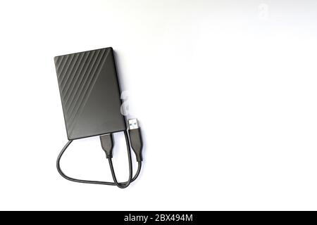 External compact SSD-drive with USB cable for writing, reading and storing data. on white background, top view Stock Photo