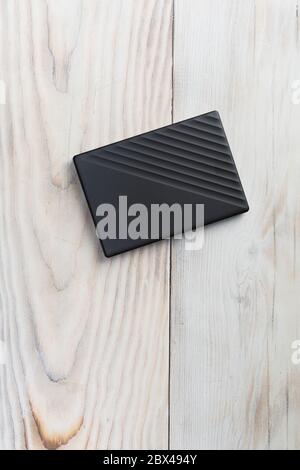 External hard drive for writing, reading and storing data on wood table Stock Photo