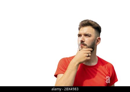 Waist up of young bearded man in red standing isolated on white background. Stock Photo
