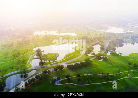 Aerial view of golf field landscape with sunrise view in the morning shot. Bangkok Thailand Stock Photo