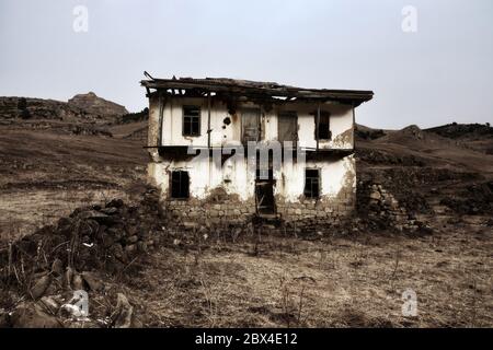 Dying mountain villages (aul) in the Caucasus. Dilapidated houses in winter. Poor farms Stock Photo