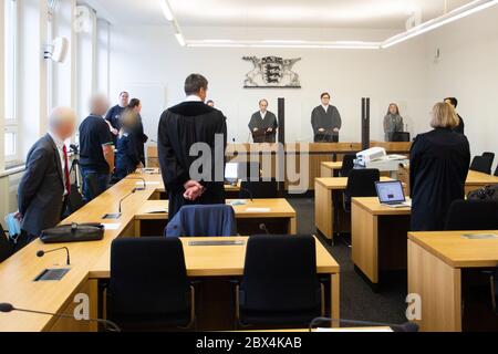 05 June 2020, Baden-Wuerttemberg, Stuttgart: The three defendants (left row) stand next to their lawyers in the courtroom at the beginning of the trial. With allegedly lucrative gold trading deals, a woman and two men are said to have robbed investors of two million euros. The trial is scheduled for the end of September. Photo: Tom Weller/dpa - ATTENTION: Person(s) has (have) been pixelated for legal reasons Stock Photo