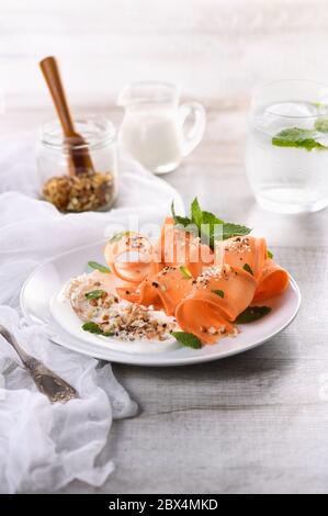 Gluten free vegetarian salad with carrot and yogurt seasoned with crushed nuts and spices, mint castings Stock Photo