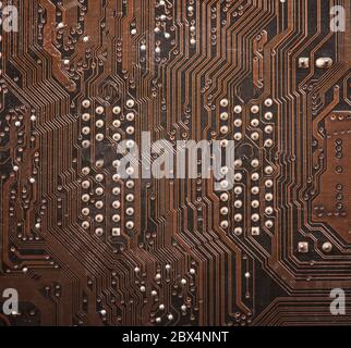 Modern printed brown circuit board, electronic circuit board, textolite. Background banner. Stock Photo