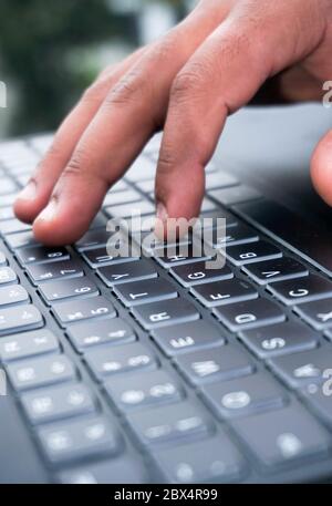 close up of a hand typing on a keyboard Stock Photo