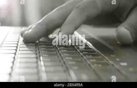 close up of a hand typing on a keyboard Stock Photo