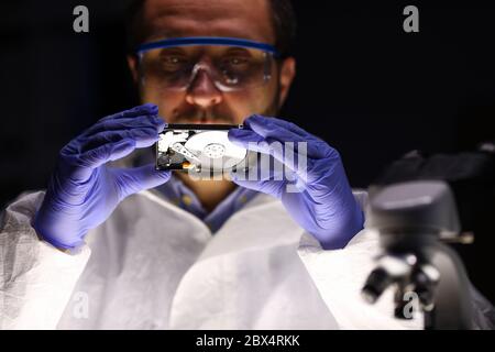 Computer master holding hdd Stock Photo