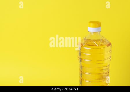 Plastic bottle with vegetable oil on a yellow background. Copy space Stock Photo