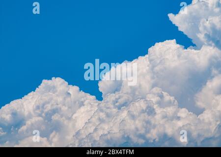 Dramatic cumulus nimbus clouds and bright blue sky over southern Cyprus on a hot summer day. Stock Photo