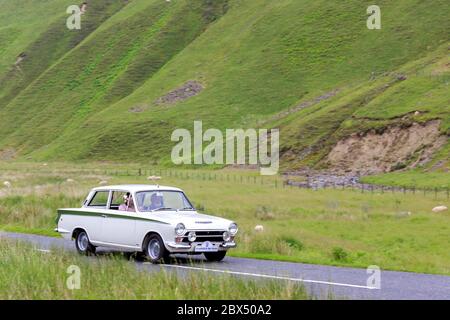 MOFFAT, SCOTLAND - JUNE 29, 2019: 1966 Ford Lotus Cortina  saloon car in a classic car rally en route towards the town of Moffat, Dumfries and Gallowa Stock Photo