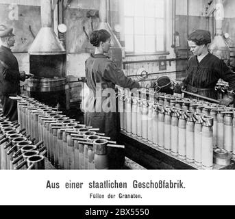 Women filling shells in a state ammunition factory. Stock Photo