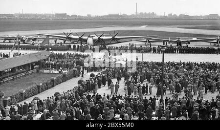 In 1933 Hermann Goering christened a Ju G 38 with the name 'Paul von Hindenburg' at Berlin-Tempelhof airport. Paul Hindenburg, Werner von Blomberg, Hermann Goering (who christened the aircraft) and Reich Foreign Minister von Neurath were all present at the christening. With a capacity of 34 passengers, the G-38 was considered the largest aircraft of its time. Stock Photo