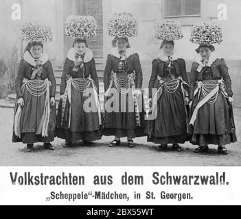 Young women from Sankt Georgen in the Black Forest wear traditional folk costumes and large bridal crowns (Schaeppel). Stock Photo