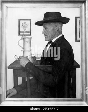 The painting 'Elsaessischer Bauer' by the painter G. Stosskopf shows a man with a hat, sitting at a table. He holds a pipe in his hand. On the table is a water jug and a glass of water. He is wearing a suit. On the wall hangs a picture with a flower vase. The picture was exhibited at the Berlin Kunsthalle in 1941 during the exhibition 'Der deutsche Mensch'. Stock Photo