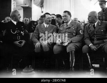 The 5th annual conference of the German Labour Front takes place in Nuremberg's Luitpoldhalle during the Reich Party Congress of Labour. The event was attended, among others, by (from left to right): Robert Ley, Adolf Hitler, Hermann Goering and Julius Streicher. Stock Photo