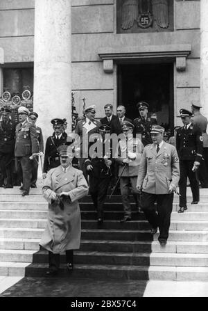 Open staircase in front of the Haus der Deutschen Kunst (today: Haus der Kunst). On the lowest step is Adolf Hitler. On the right side of the stairs is Wilhelm Brueckner and in the background at left Hermann Goering. Left of the Wehrmacht officer next to Brueckner, Julius Schaub. Stock Photo