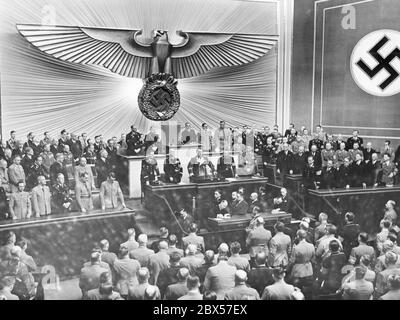 Hermann Goering during the closing speech of the Reichstag session in the Berlin Kroll Opera House on March 18, 1938. On the left in the government bench: Joseph Goebbels, Wilhelm Frick, Joachim von Ribbentrop, Rudolf Hess and Adolf Hitler, Franz Seldte, Hanns Kerrl, Bernhard Rust, Franz Guertner and Walther Funk, in the third row Johannes Popitz, Otto Meissner, Walther von Brauchitsch and Wilhelm Keitel (each from left to right) On the right, the bench of the Austrian Provincial Government under Arthur Seyss-Inquart (front left). Stock Photo