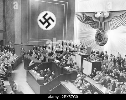 Adolf Hitler's speech in front of the Reichstag in the Berlin Krolloper on March 20, 1938. Above is Hermann Goering as President of the Parliament, on the left in the government bench Johann Ludwig Graf Schwerin von Krosigk, Konstantin von Neurath, Joseph Goebbels, Wilhelm Frick, Joachim von Ribbentrop and Rudolf Hess, above, Erich Raeder, Wilhelm Ohnesorge, Julius Dorpmueller, Hans Frank, Franz Seldte, Hanns Kerrl, Bernhard Rust, Franz Guertner and Walther Funk, in the third row Johannes Popitz, Otto Meissner, Walther von Brauchitsch and Wilhelm Keitel (all from left to right) Stock Photo