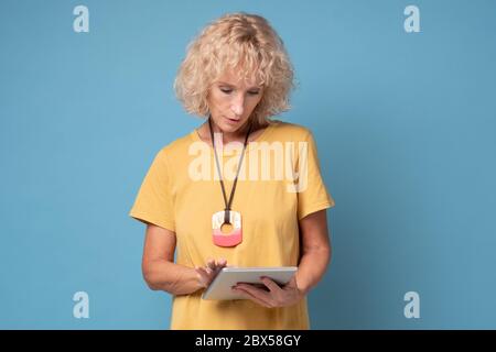 woman using a tablet computer selecting goods in online shop Stock Photo