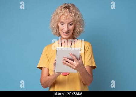woman using a tablet computer selecting goods in online shop Stock Photo