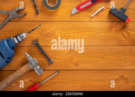 Top view layout of tools for repair on wooden background, free space for text Stock Photo