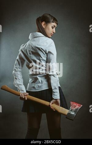 Dangerous psycho girl with axe full of blood Stock Photo