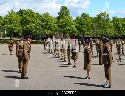 Recruits are inspected during a passing out parade at Sir John Moore Barracks, Winchester, the first batch of soldiers to complete their training in the Army Training Regiment (Winchester) since the coronavirus lockdown. Stock Photo