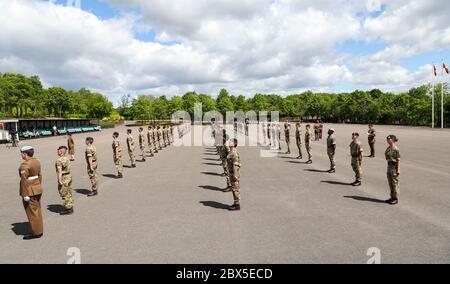 Recruits are inspected during a passing out parade at Sir John Moore Barracks, Winchester, the first batch of soldiers to complete their training in the Army Training Regiment (Winchester) since the coronavirus lockdown. Stock Photo