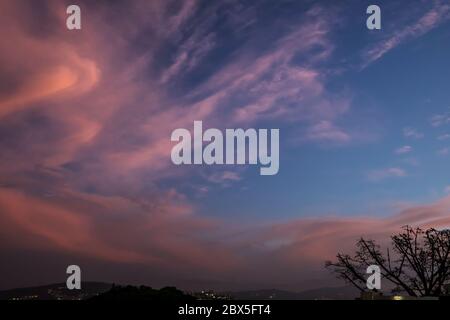 Cirrus Clouds in Caracas' sky at sunset Stock Photo