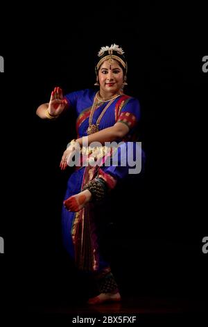 Bharatnatyam dancer standing in a natraj pose during her performance. Stock Photo