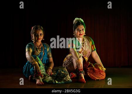 Bharatnatyam dancer performing with her young student. Stock Photo